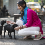 A girl caring for a stray dog under Human Capital Exponential